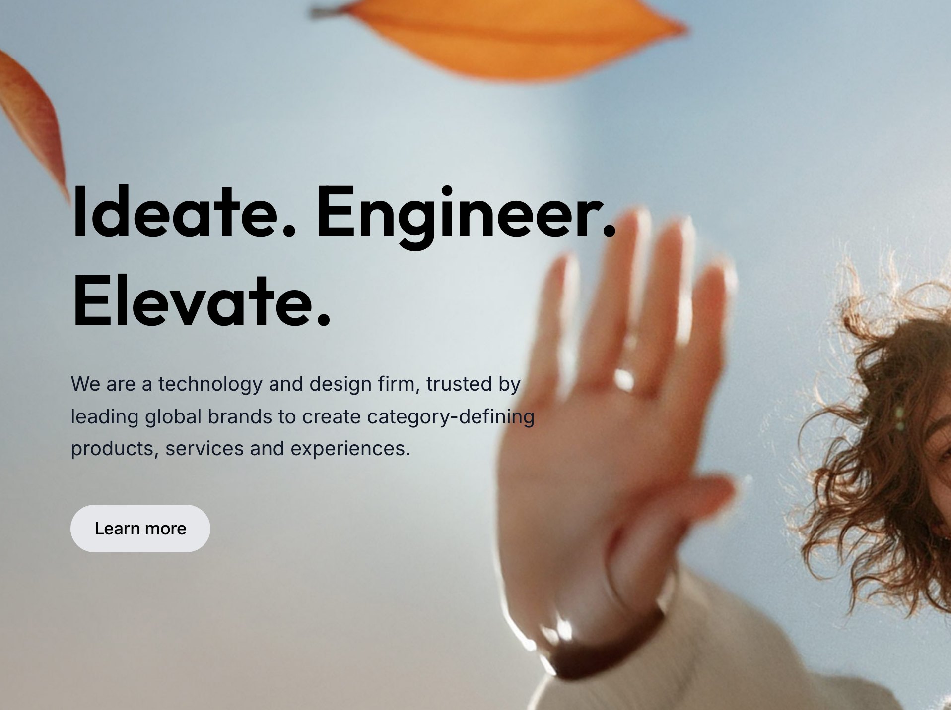 Hero of the Elevate homepage: the headline Ideate. Engineer. Elevate. over a photo of a woman reaching toward falling autumn leaves