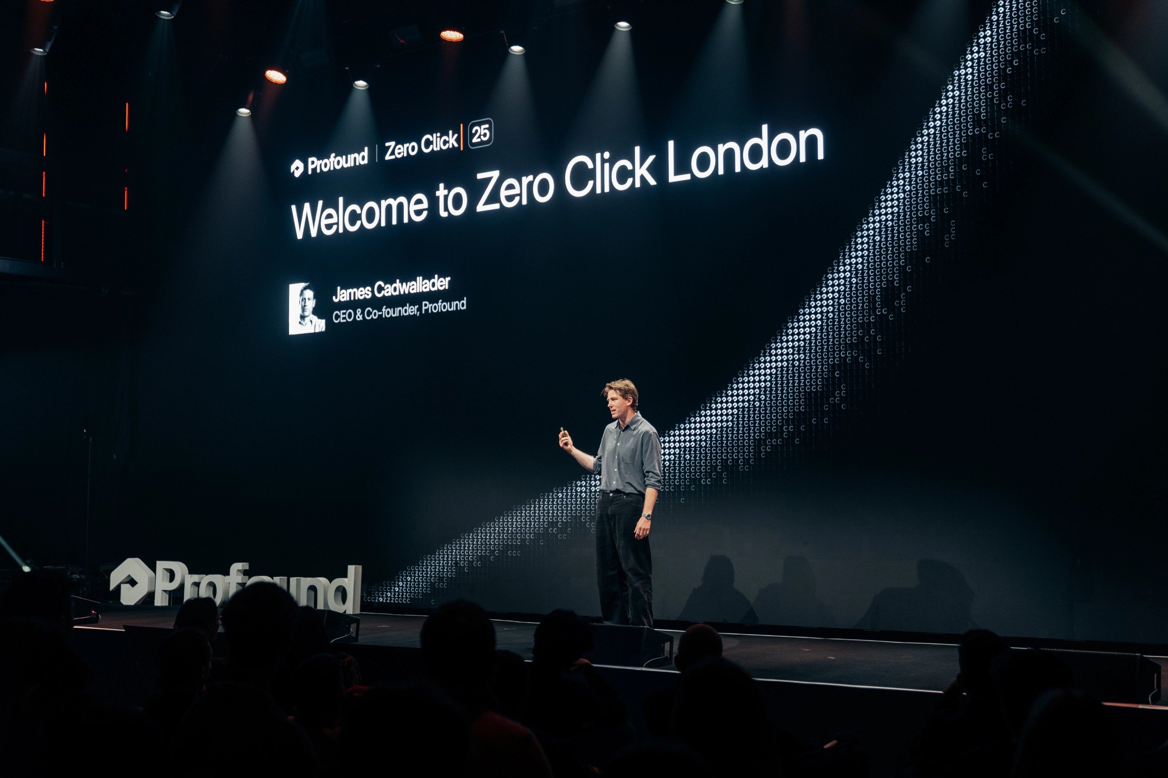 James Cadwallader on stage under a large screen reading Welcome to Zero Click London, with his title CEO and Co-founder of Profound